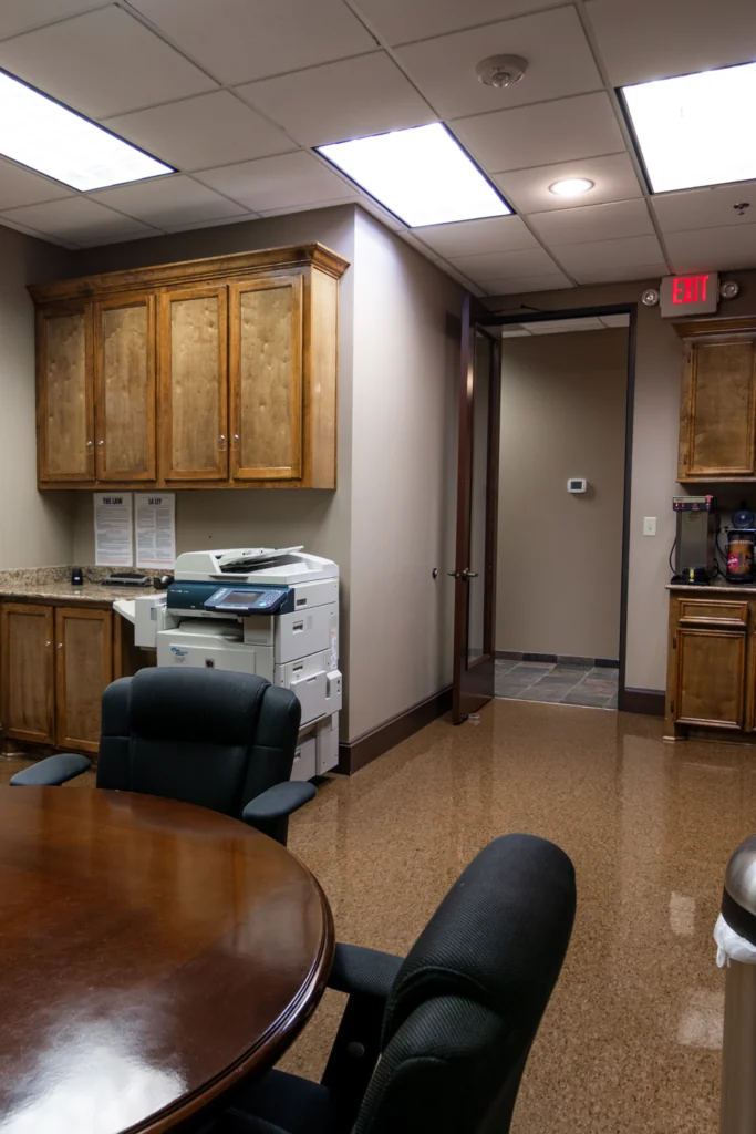 Shared breakroom with a round table, chairs and kitchenette