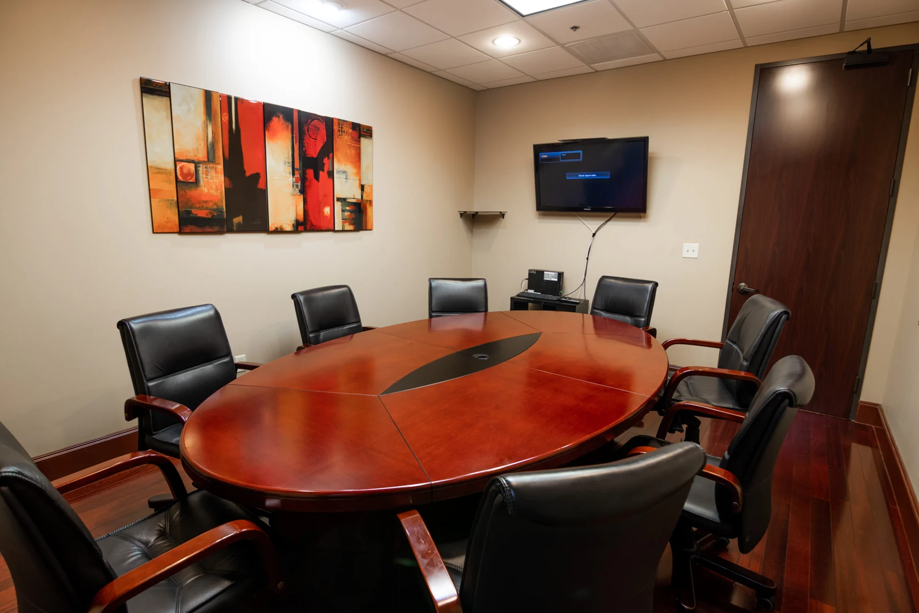 Shared conference room with a wood meeting table