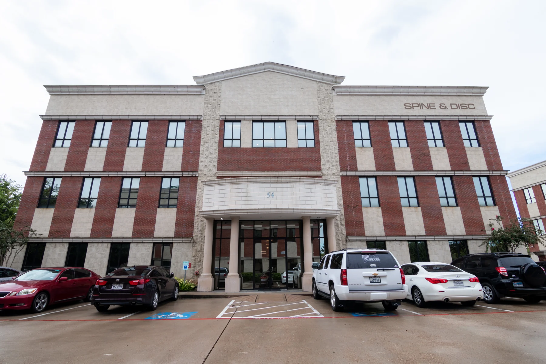 Brick-column entrance to the office building at 54 Sugar Creek Center Boulevard